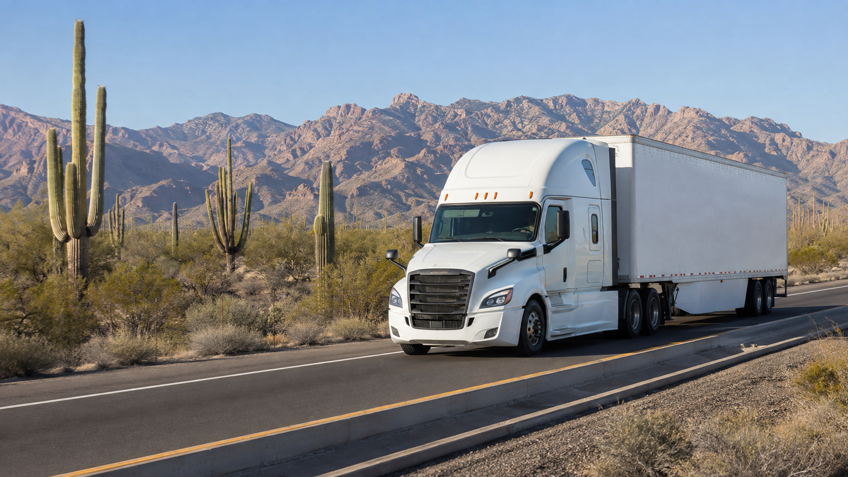 White tractor-trailer traveling through a Sonoran Desert highway scene